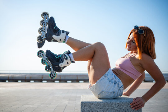 Woman relaxing outdoors wearing rollerblades enjoying summer activity