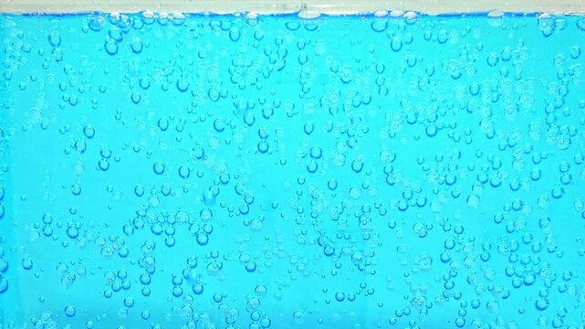青い炭酸水の中に湧き上がる爽やかな気泡と泡の清涼感あふれる背景