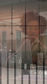 Animation of financial data processing over diverse business people using laptop in office
