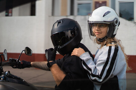 Girl looks back from motorcycle passenger seat