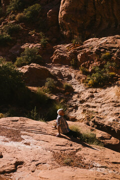 Older man resting on a rock during a desert hike