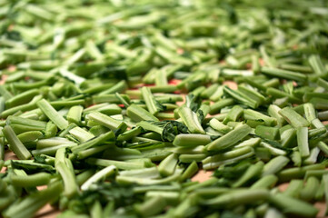 Fototapeta premium Mustard greens cut into strips cover a timber board, natural cut marks on the stems, Huaxin Street, Zhonghe District, New Taipei City, before sun-drying.