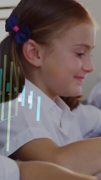 Graph animation over school children studying on tablets in classroom
