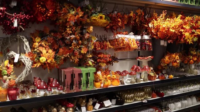 Autumn store display filled with pumpkins maple leaves berries mushrooms wreaths and seasonal decorations creates a cozy fall harvest atmosphere for festive home decorating