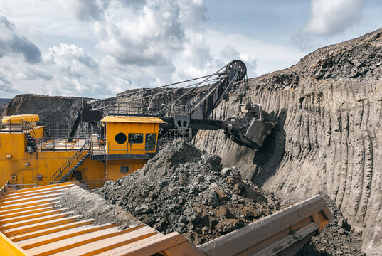 Process of removing overburden soil in quarry, Aerial view. Industrial machinery at open pit coal mine extracting resources