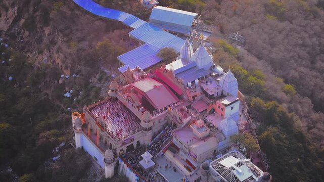 Cinematic Drone Shot of Radha Rani Temple and Barsana Village During the Famous Holi Festival with Thousands of Devotees, Color Clouds and Vibrant Braj Celebrations