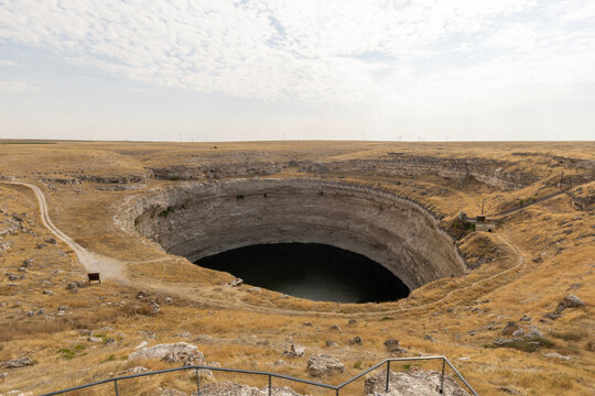Wide angle high angle view of the historic Kız&ouml;ren Sinkhole (Obruk), a 2-million-year-old geological wonder and deep natural crater lake situated in the dry steppe landscape of Konya, Central Anatolia