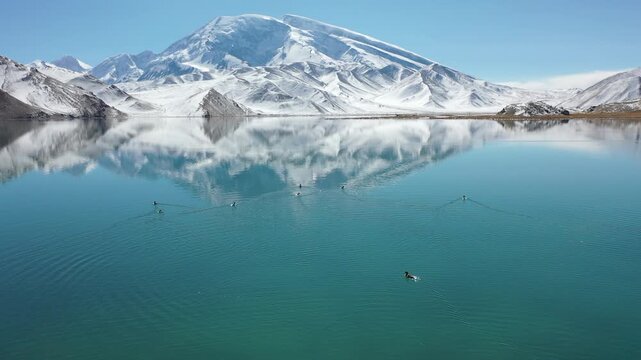 Aerial view of Muztagh Ata peak reflected in Karakul Lake, Xinjiang, China