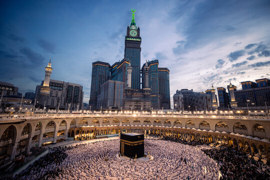 Pilgrims surround the Kaaba at dusk creating a sea of devotion under the evening sky