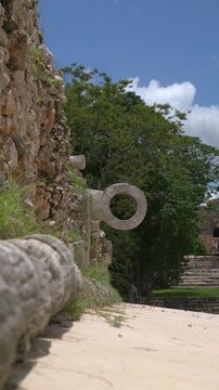 Vertical 9:16 shot of the carved Mayan ballcourt stone ring on stone wall at Uxmal archaeological site in Yucatan, Mexico.