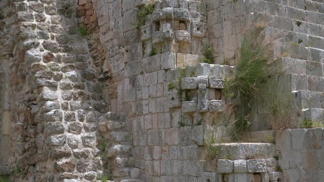Slow tilt down shot of intricate Chaac masks and ancient stone steps on the Magician Pyramid at Uxmal archaeological site in Yucatan, Mexico.