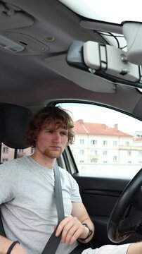 Vertical screen driver sits calmly with his seat belt already fastened showing responsible road safety behavior and proper preparation before starting the planned journey