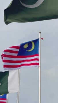 Two Country Flags of Pakistan and Malaysia Waving Together in an Endless Seamless Loop