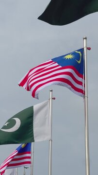 National Flags of Pakistan and Malaysia Waving Together, International Cooperation Concept