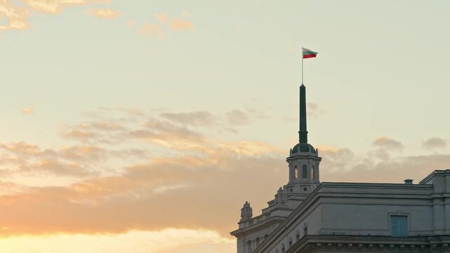 Bulgarian Flag Waving on Top of Parliament Building Spire in Sofia City at Sunset Sky