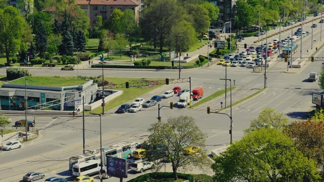 Elevated View of Busy City Traffic Intersection at NDK Park with Cars Buses and Greenery in Sofia