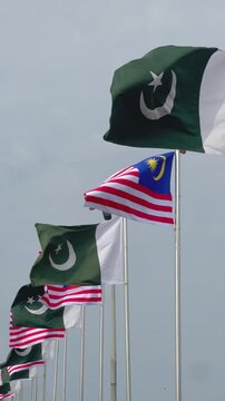 Pakistan and Malaysia Partnership Concept with Two National Flags Waving in the Wind