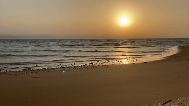 Video of a golden sunset over the sea from a sandy beach at Ras Sudr, Egypt