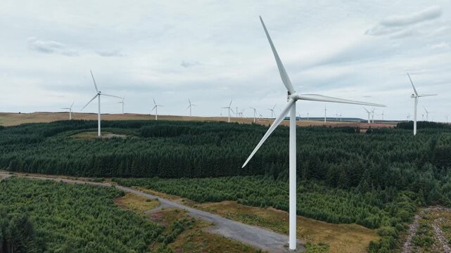 Gigantic Clocaenog Dau Wind Farm turbine - drone close-up slow pan across blades , North Wales, UK