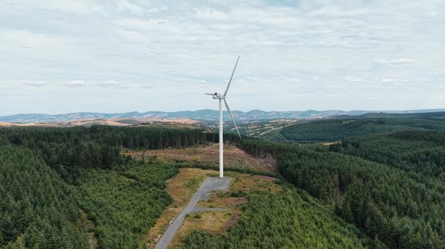 Gigantic Clocaenog Dau Wind Farm turbine - drone approach from far , North Wales, UK
