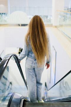 Customer Standing on Moving Escalator in Mall
