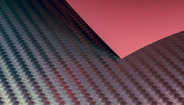 Close-up view of carbon fiber fabric with red paper overlay