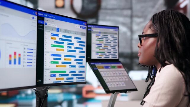 Hotel Manager Carefully Checks Room Availability On Laptop