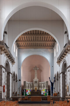 Decorated church apse with mosaic altar and wooden pews