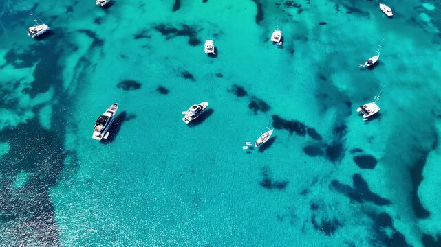 Aerial view of yachts anchored in turquoise water at Brandinchi beach, Sardinia