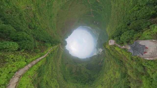 Drone view tunnel effect landscape of green mountains, footpath, Chinese style pavilion in Fengtang village, Hechi, Guangxi, China, 4k real time footage travel concept b roll shot.