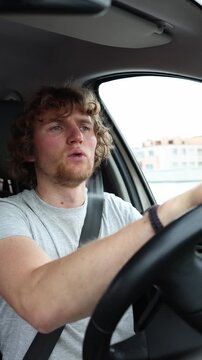 Vertical screen nervous driver does not know how to drive confidently and struggles with vehicle control while reacting anxiously to changing traffic on a busy urban road