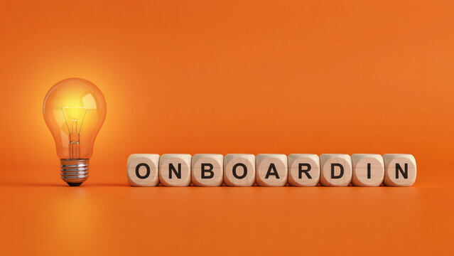 Onboarding word spelled out with wooden blocks and a glowing light bulb
