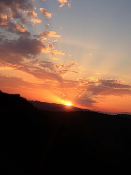 Golden hues dance across the sky as the sun dips below the horizon, calm, nature
