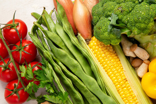 Different fresh vegetables as background.