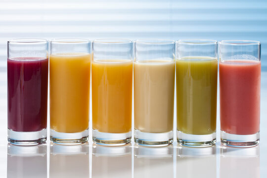 Variety of fruit smoothies in glasses, close up