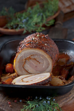 Sliced rolled roast pork with braised vegetable in a pan