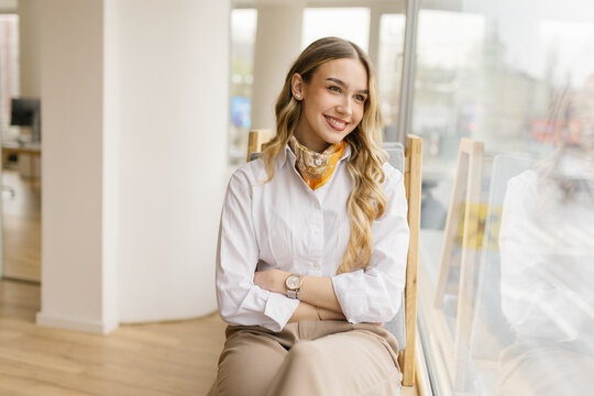 Smiling businesswoman enjoys a break at the modern office