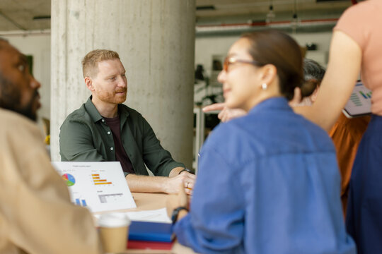 Business people discussing financial charts during a meeting in modern office