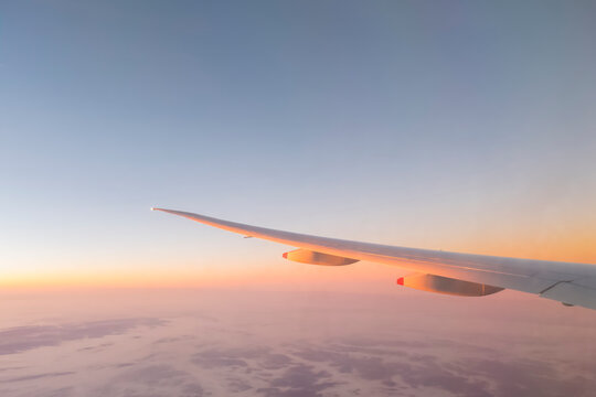 Europe, wing of an airplane with clouds at sunrise