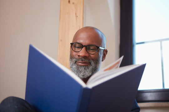 Portrait of man reading a book