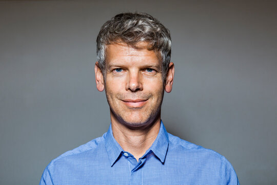 Portrait of smiling mature man with grey hair