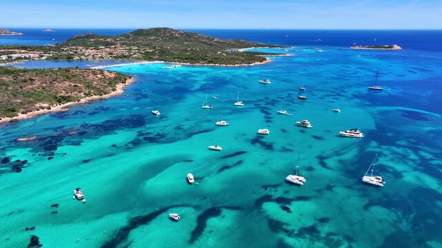 Aerial view of yachts anchored in turquoise water at Brandinchi beach, Sardinia