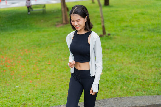 Asian sporty woman running in public park