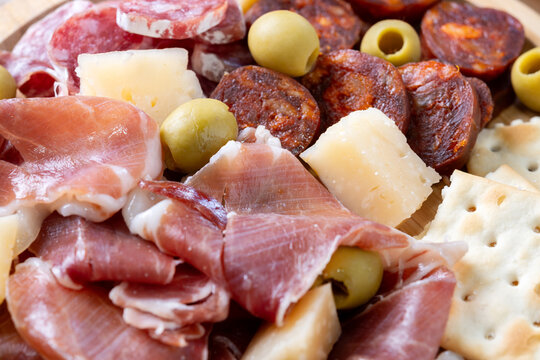 Spanish charcuterie platter with cured meats, cheese and olives. Close up