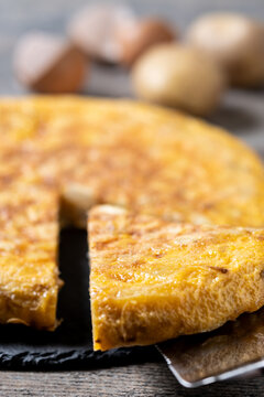 Slice of Traditional Spanish Potato Omelette on wooden table