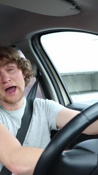 Vertical screen impaired driver operates a moving car under the influence of narcotics creating a serious threat to road safety while traveling through busy urban traffic