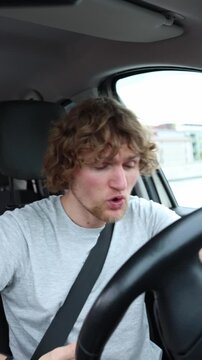 Vertical screen driver becomes nervous behind the wheel and struggles to stay calm while moving through heavy urban traffic during a stressful and demanding daily commute
