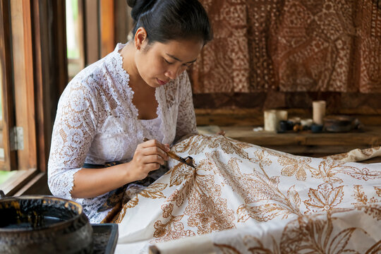 traditional indonesian woman making handmade batik tulis with canting
