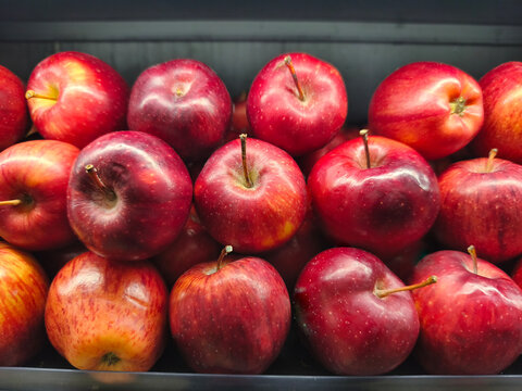 Fresh Red Apples Displayed in a Grocery Store

Close-up view of fresh ripe red apples arranged in a grocery store display. Colorful apples with natural texture and stems, suitable for food, healthy ea