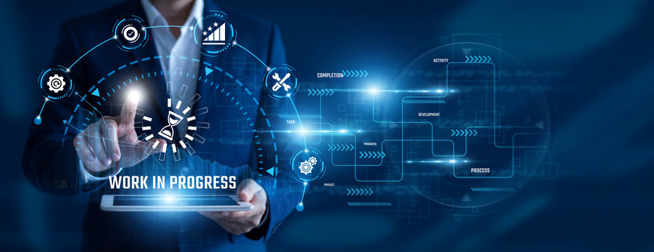 Project Manager using tablet analysing Work In Progress data. Project tracking, development stages, task monitoring, workflow progress, team coordination, operational planning.